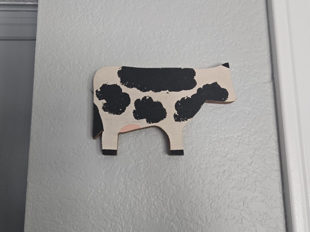 Wooden cow art on wall