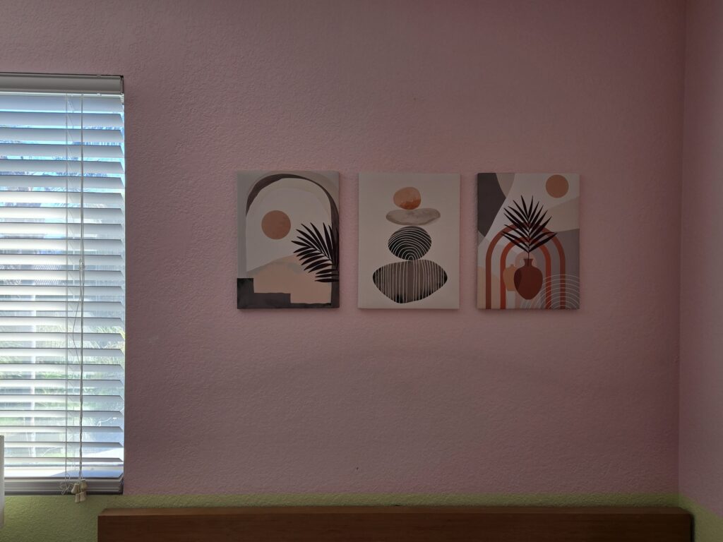 Three boho prints on pink wall