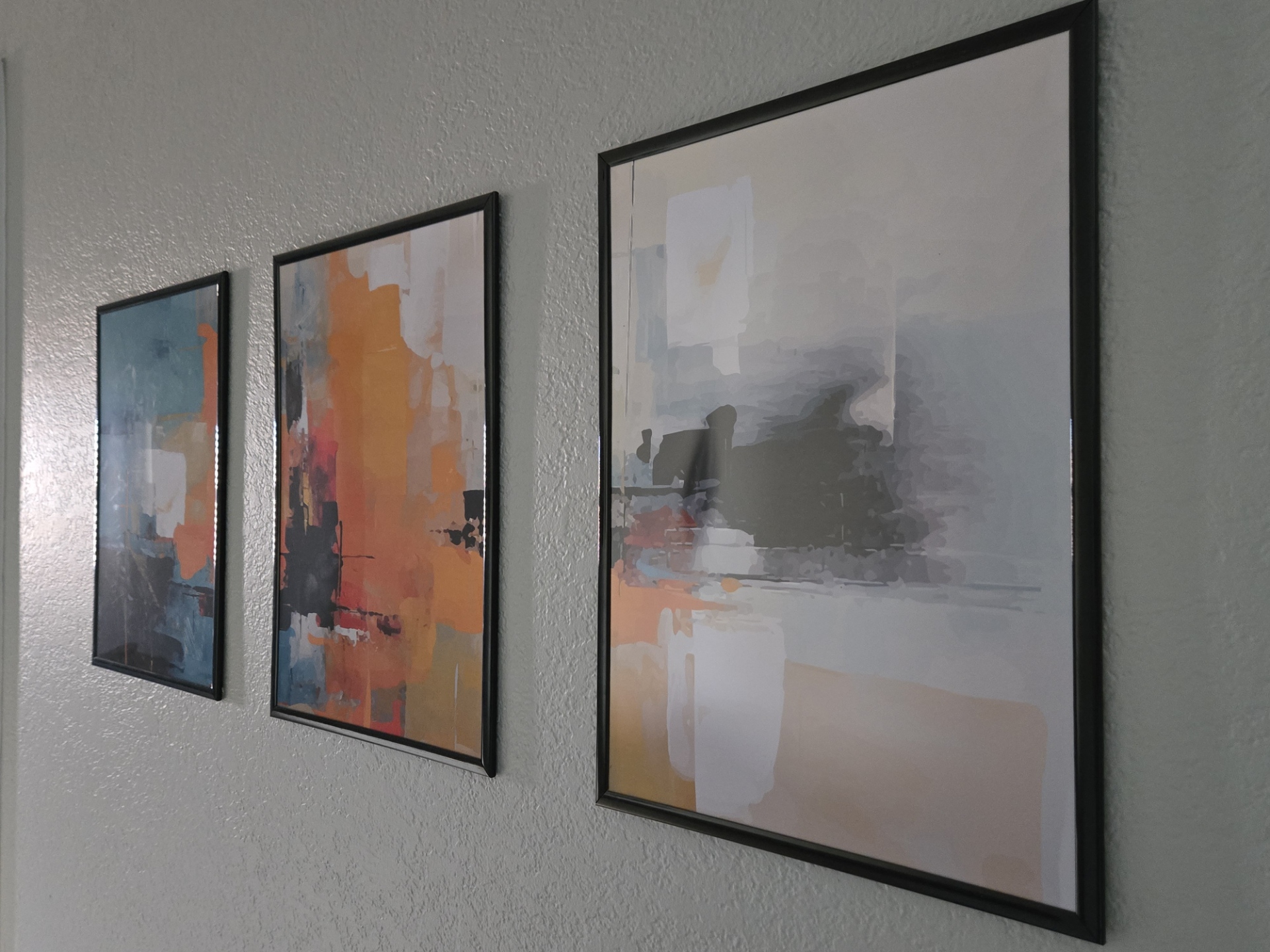Three abstract prints in hallway